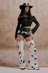 MOO OVER COW PRINT FAUX LEATHER CHAPS