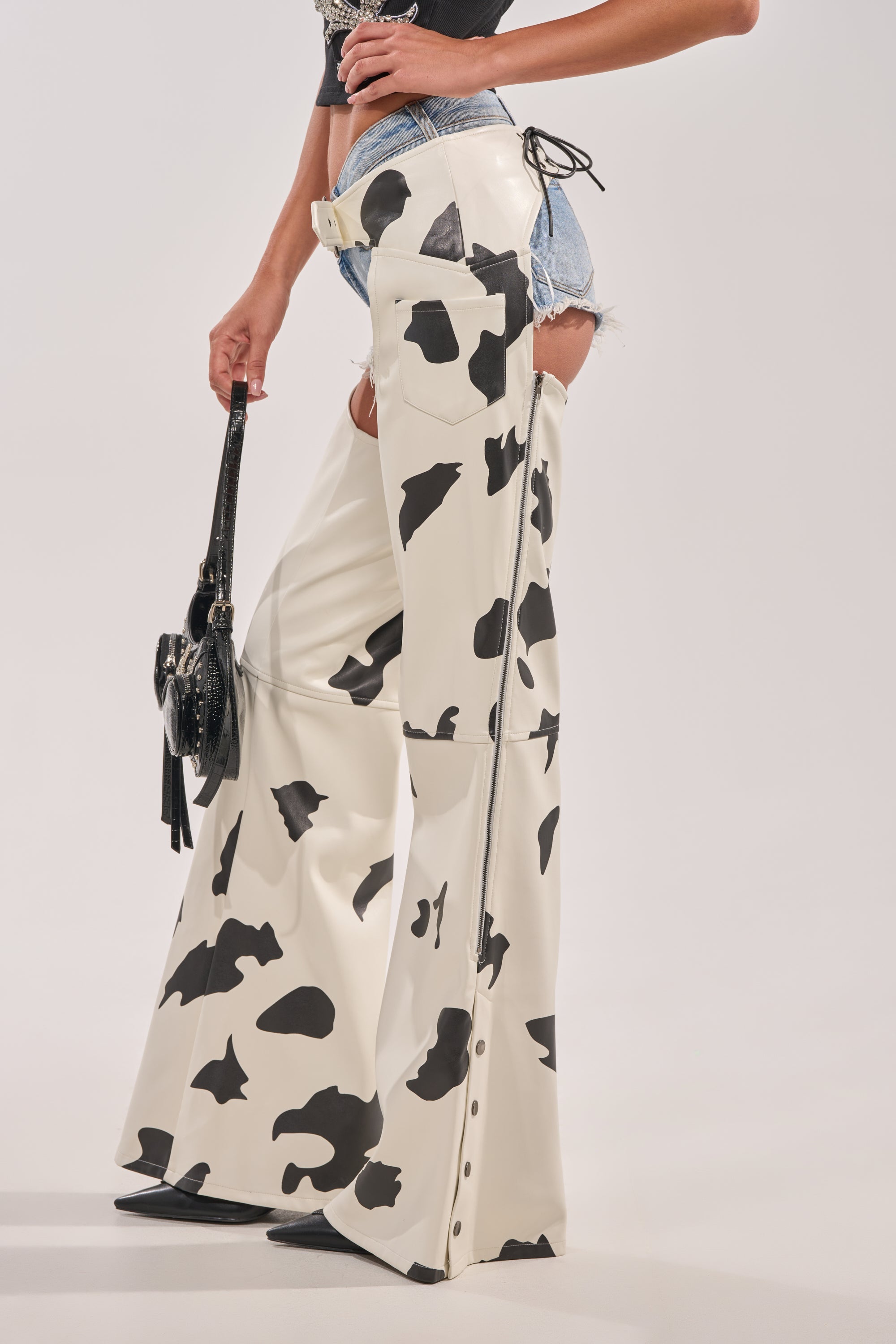 MOO OVER COW PRINT FAUX LEATHER CHAPS