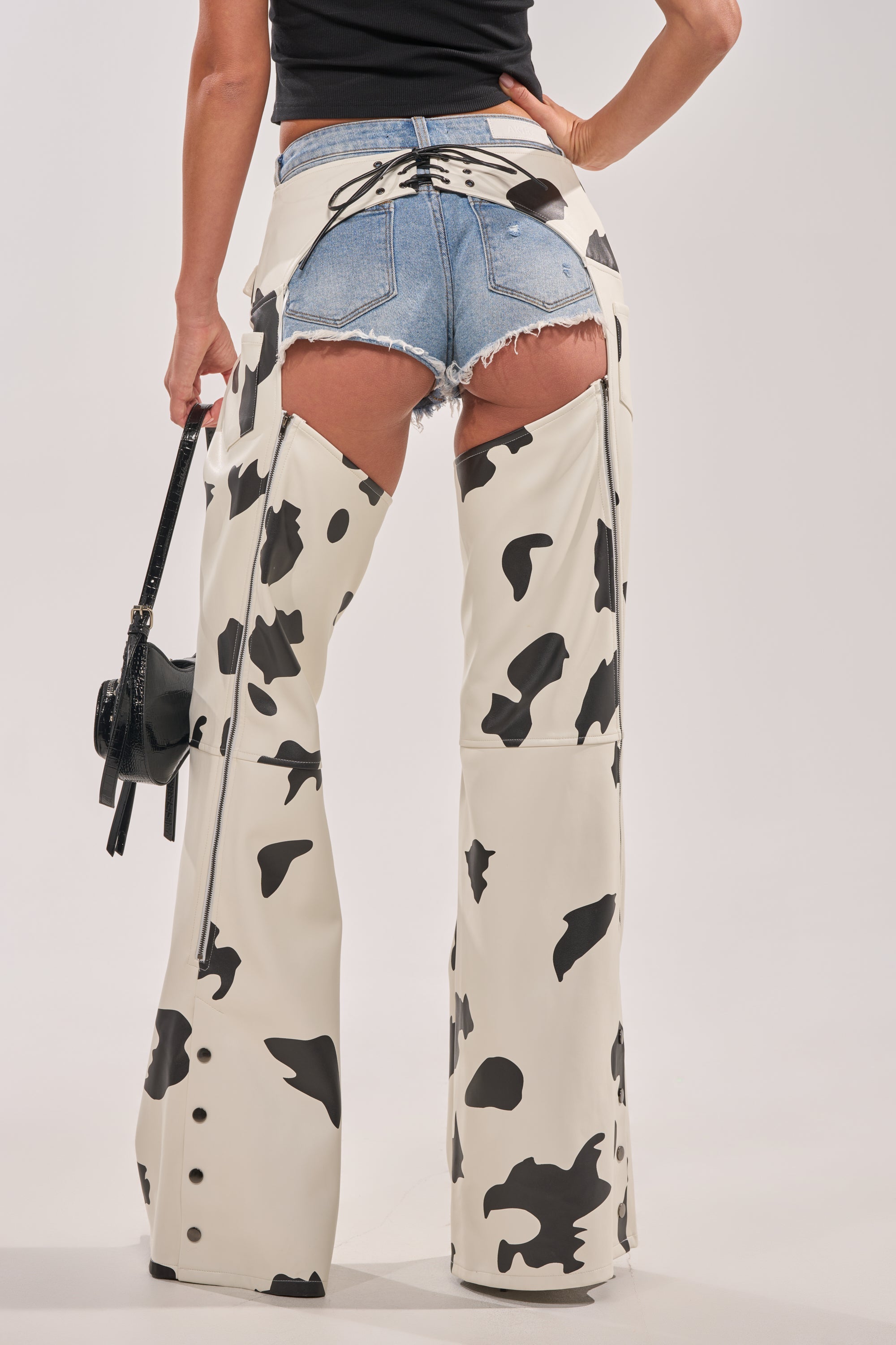 MOO OVER COW PRINT FAUX LEATHER CHAPS
